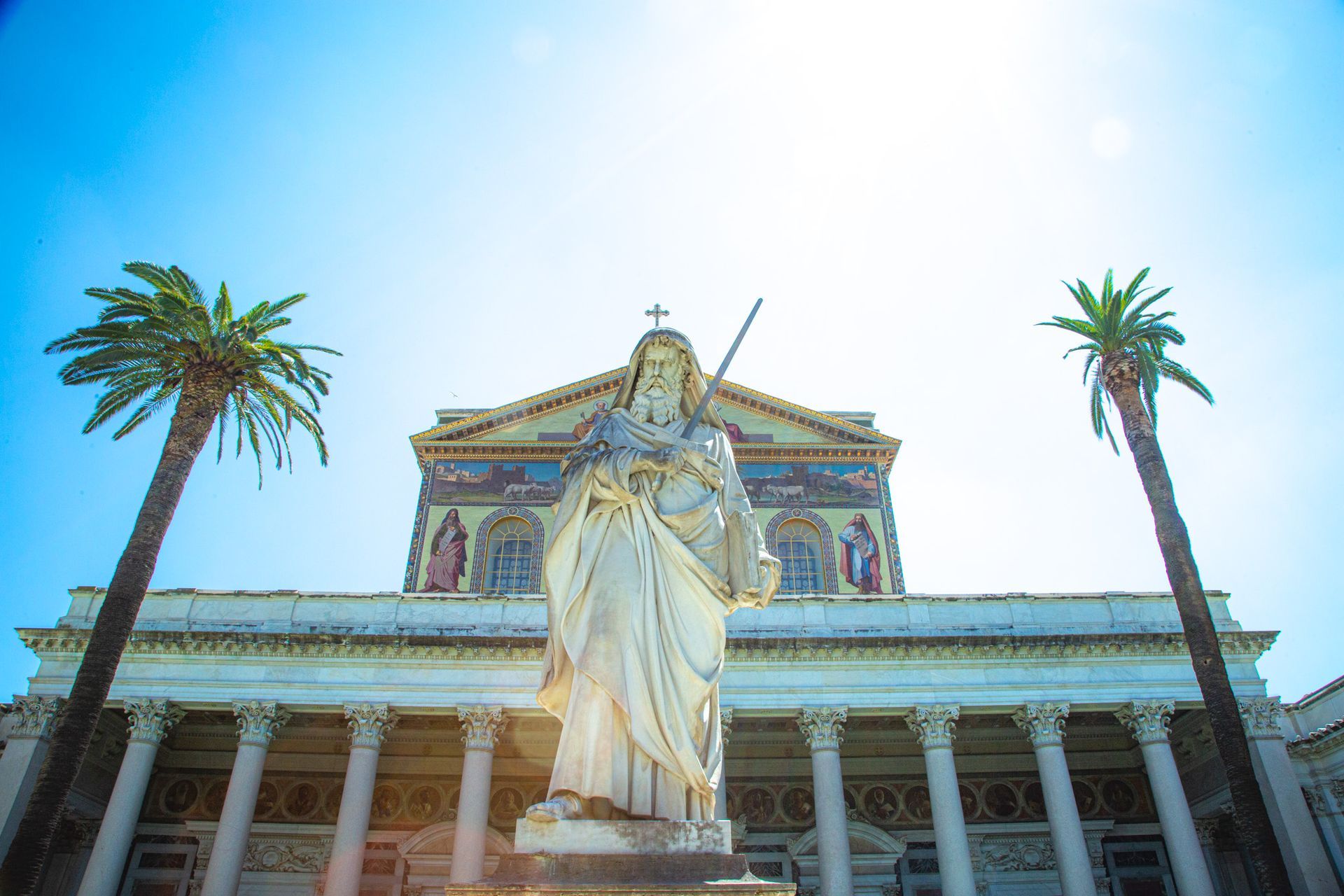 St. Peter's Basilica with rainbow arching overhead; Rome, Italy.