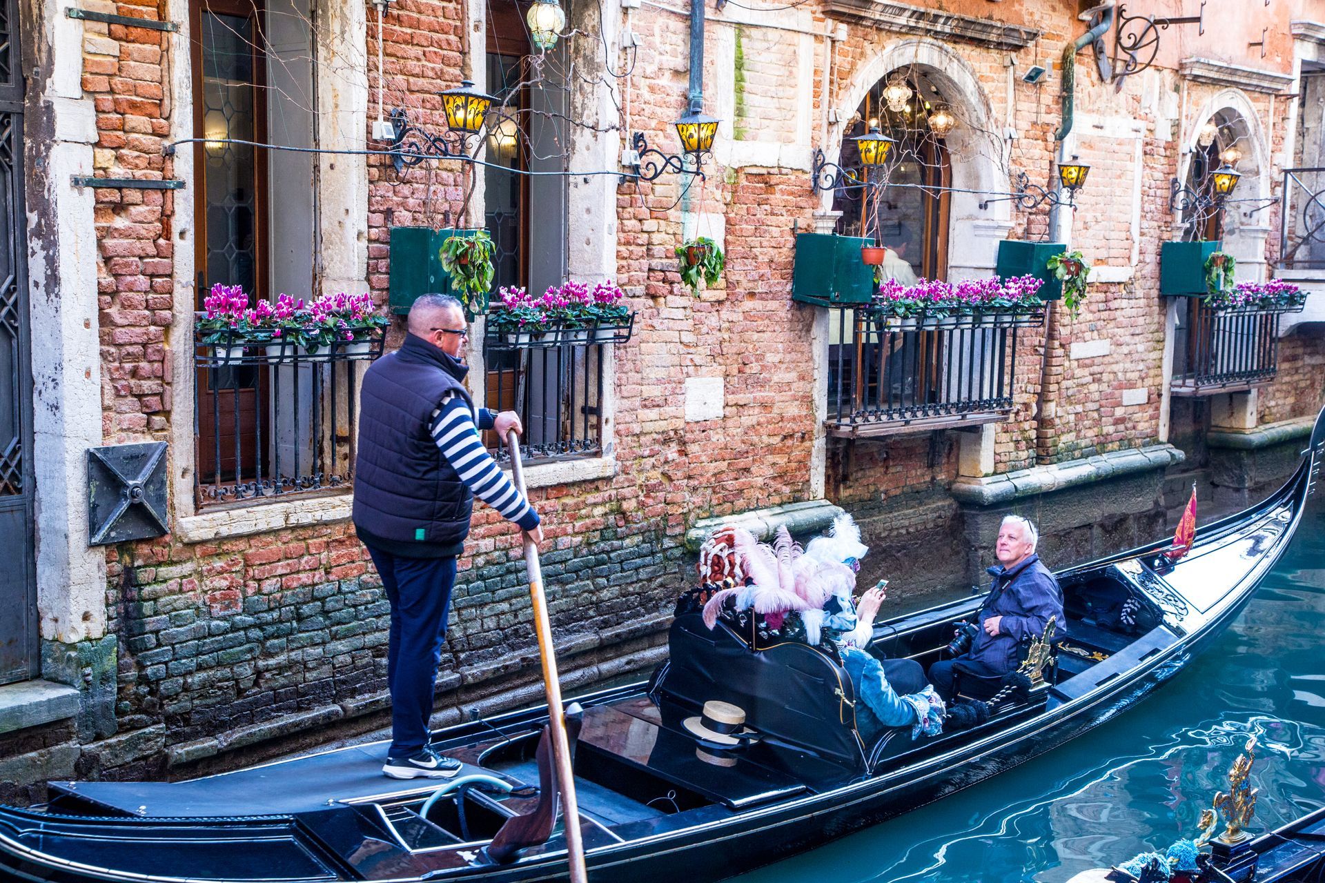 People riding in a gondola in Venice.