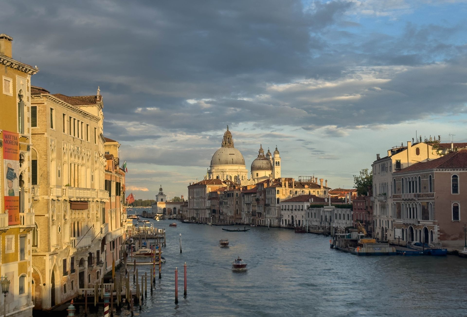View of buildings and boats on a canal in Venice.