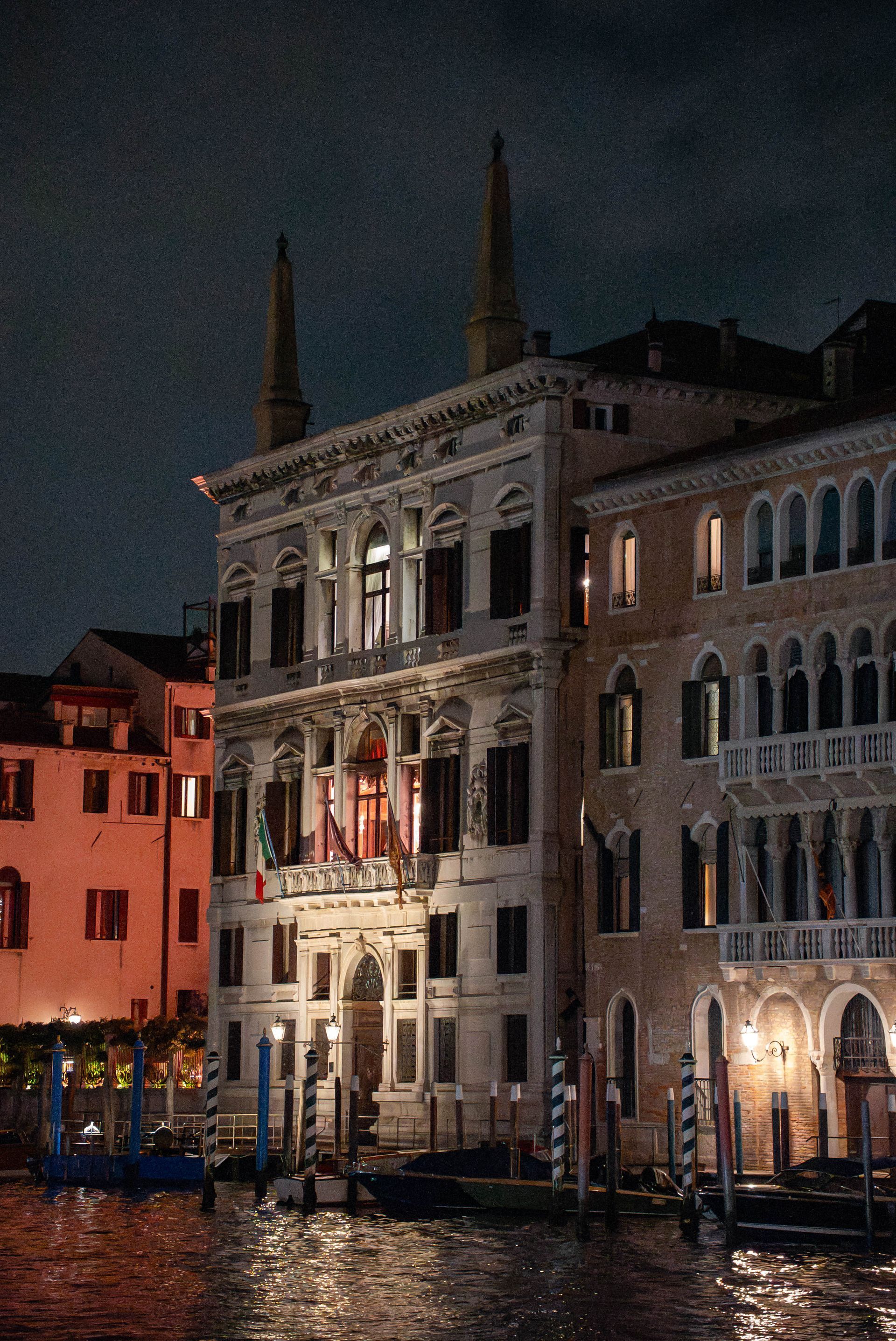 Beautiful old building on the canal in Venice at night.