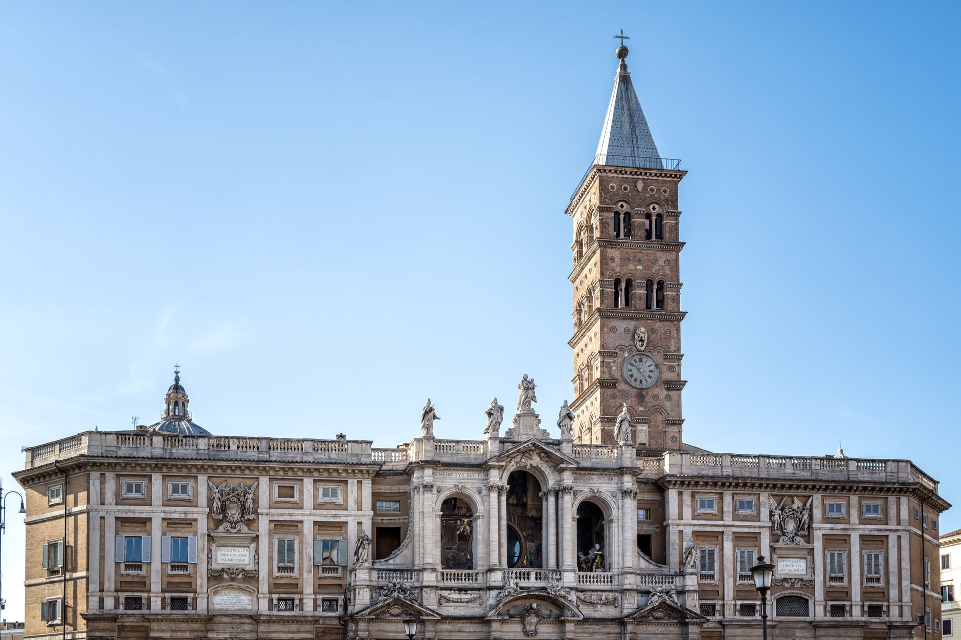 Basilica di Santa Maria Maggiore, Rome. Large church facade with tall bell tower against a blue sky.