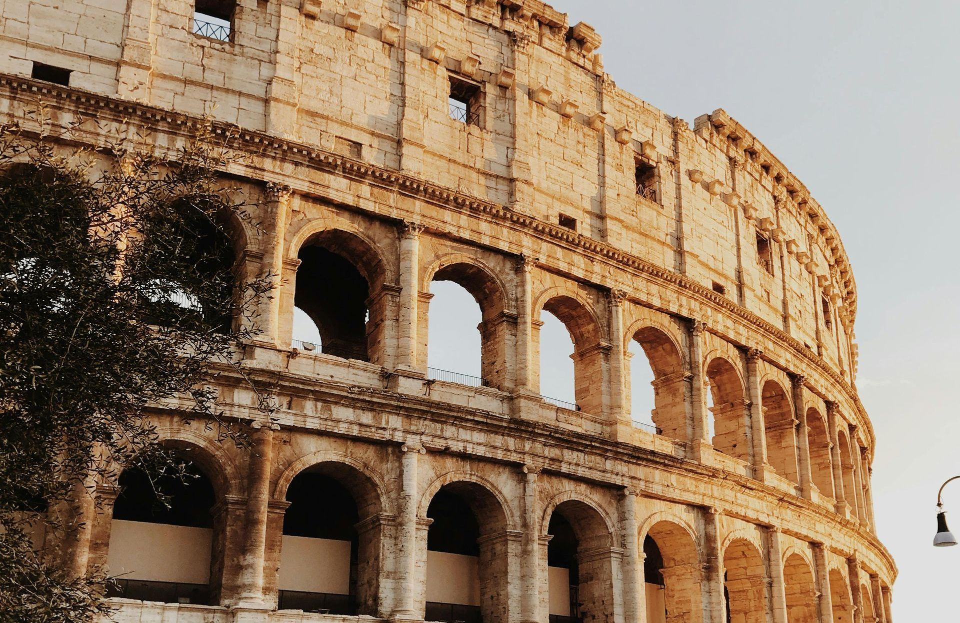 Colosseum in Rome, Italy; exterior view of ancient stone amphitheater.