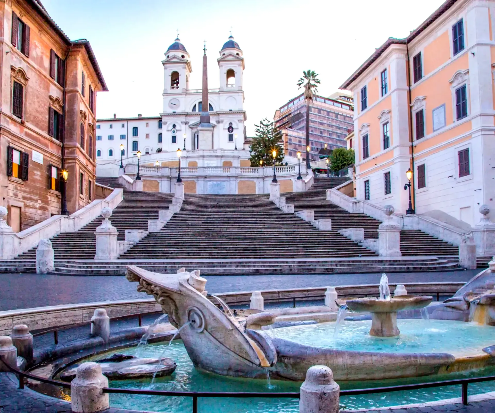 Spanish Steps and Fountain in Rome. Stone staircase, fountain with sculpture, buildings.