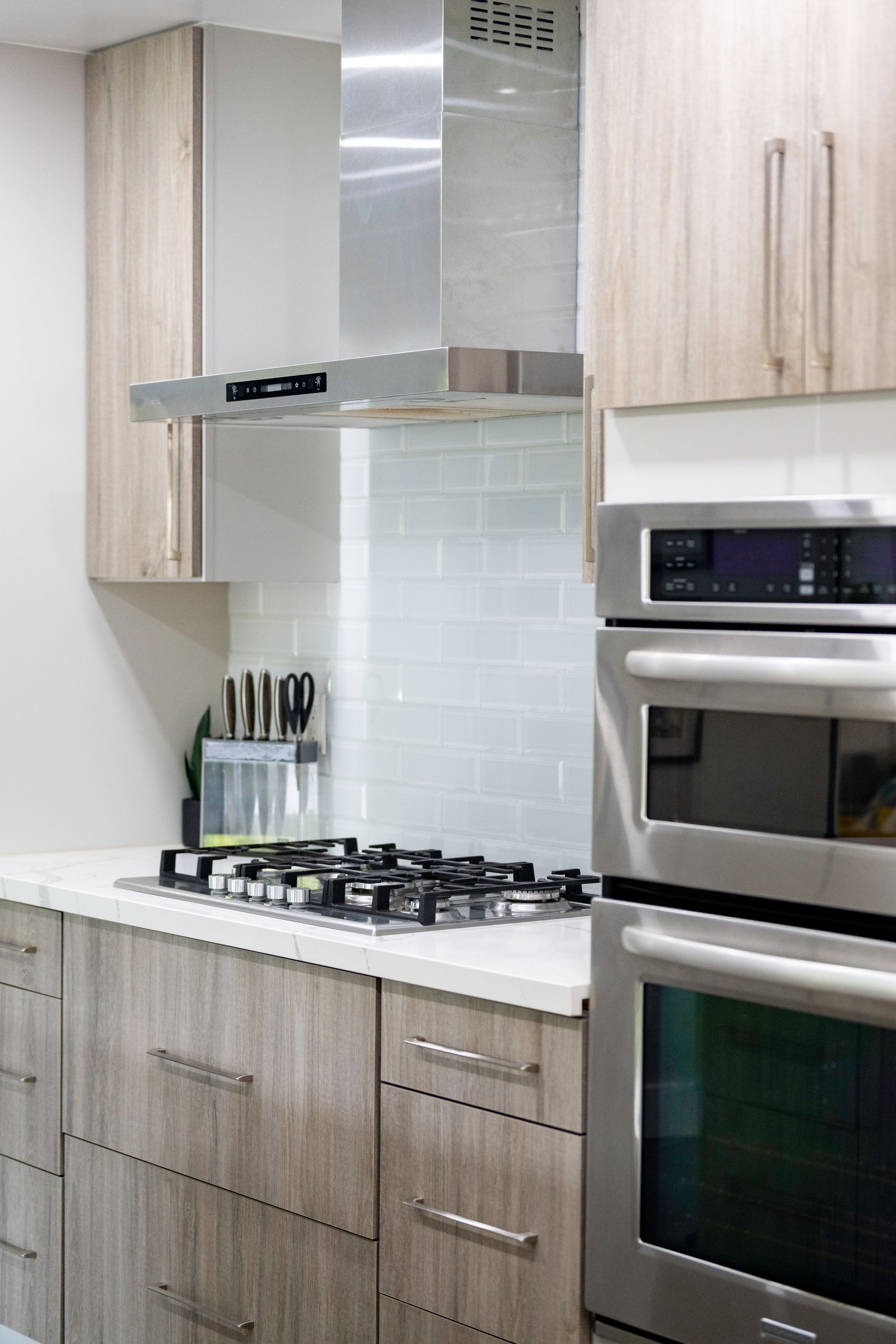 A kitchen with stainless steel appliances and wooden cabinets.