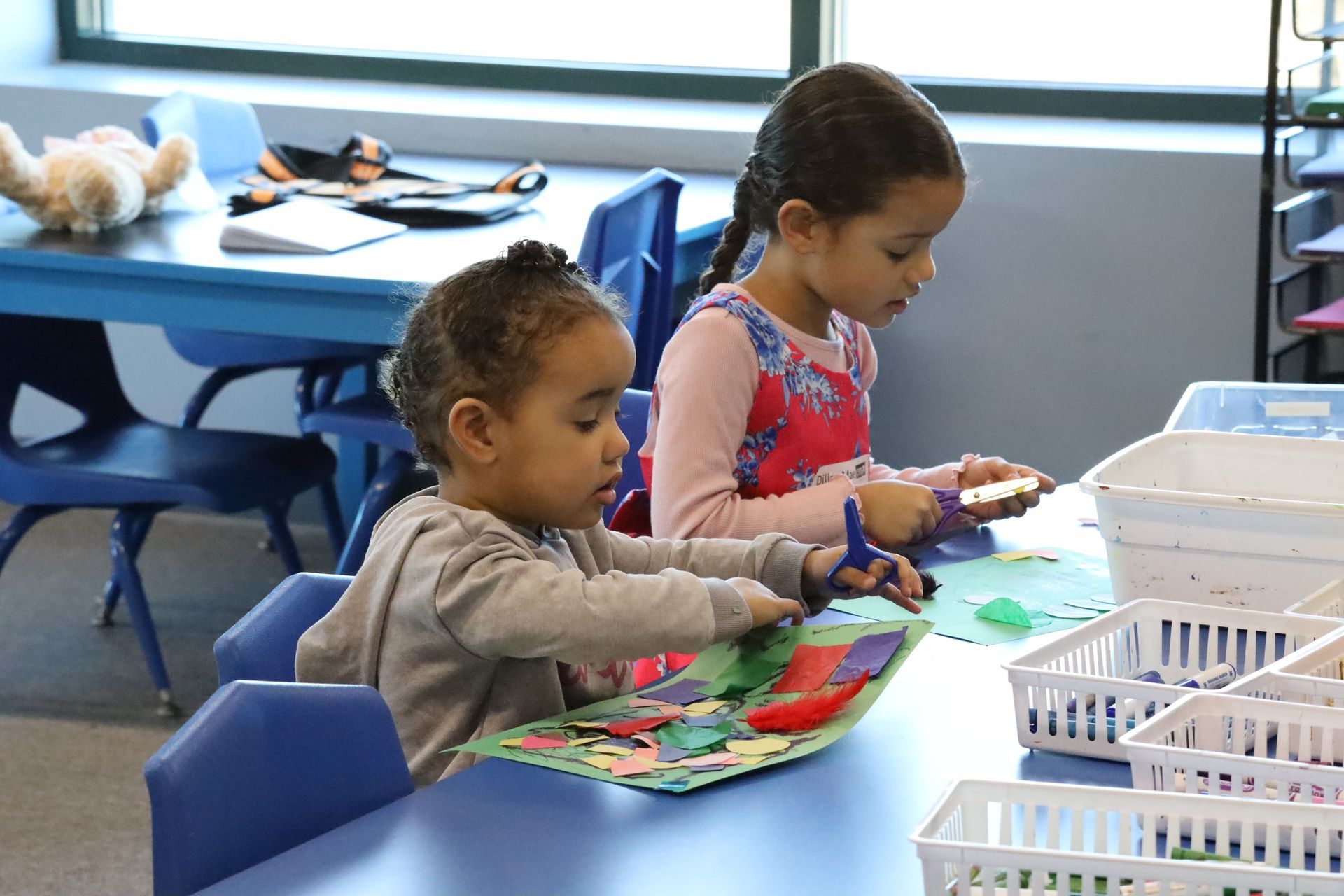 a little girl in a red dress is playing with a toy castle