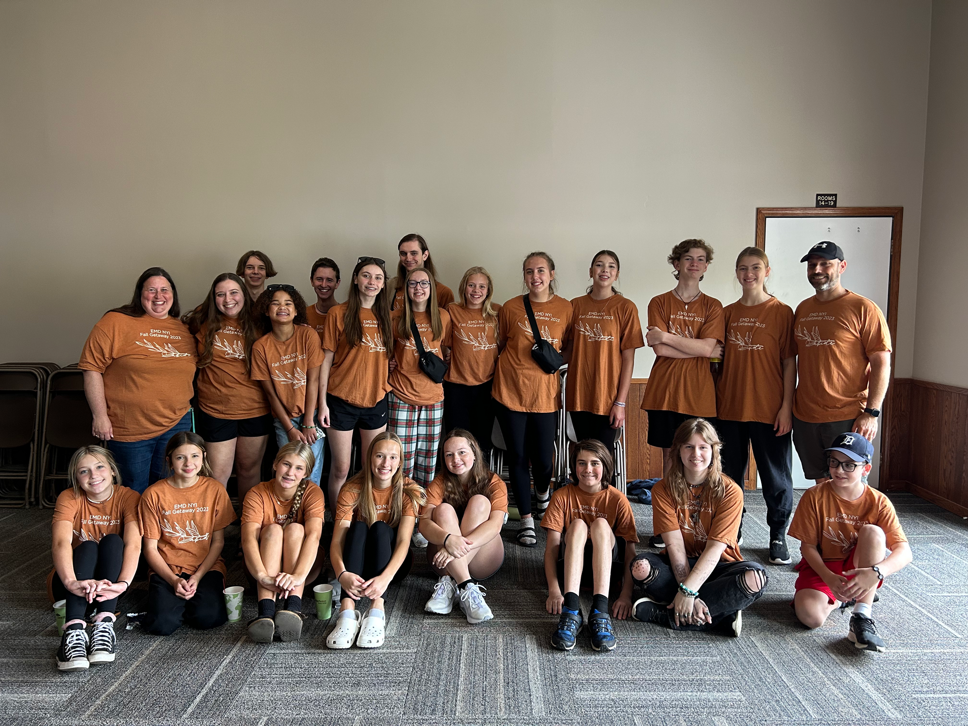 two girls are standing next to each other in front of a blackboard .