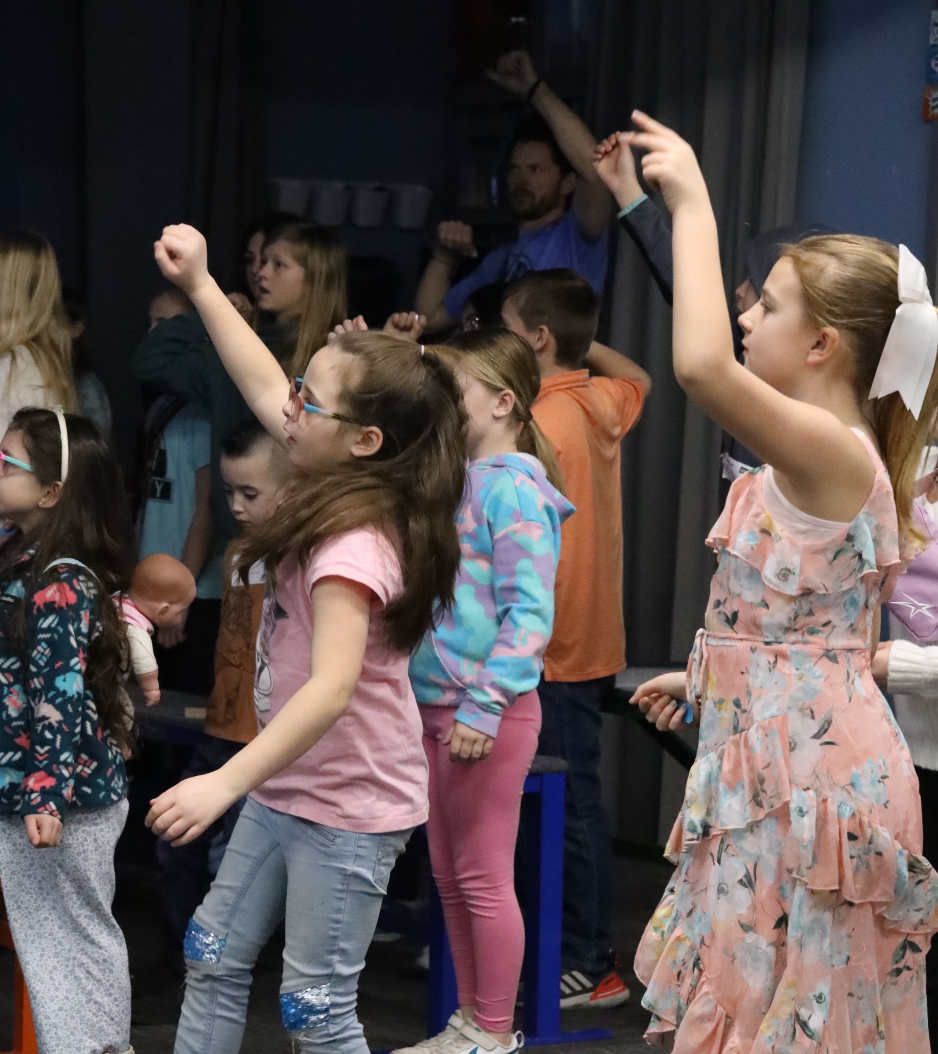 a boy and a girl are sitting on a swing .