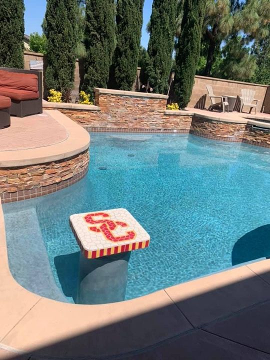 A swimming pool with a stool that says uc on it