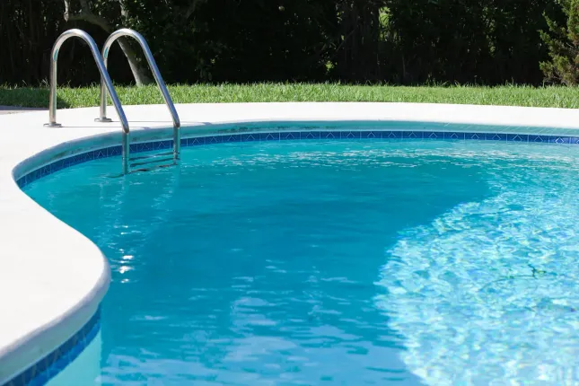 A large swimming pool with stairs leading to it
