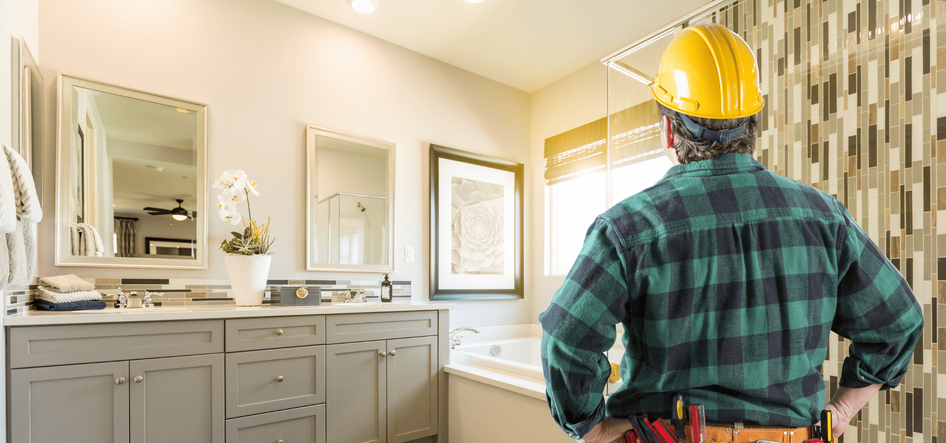 Employee from Denver Bathroom Pros looking at a finished bathroom remodel