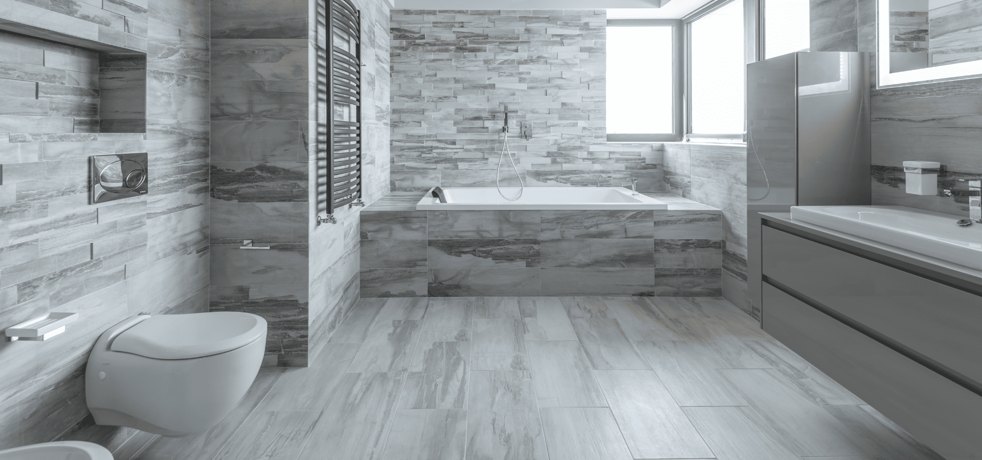 Gray vinyl flooring and walls in a large, spacious bathroom