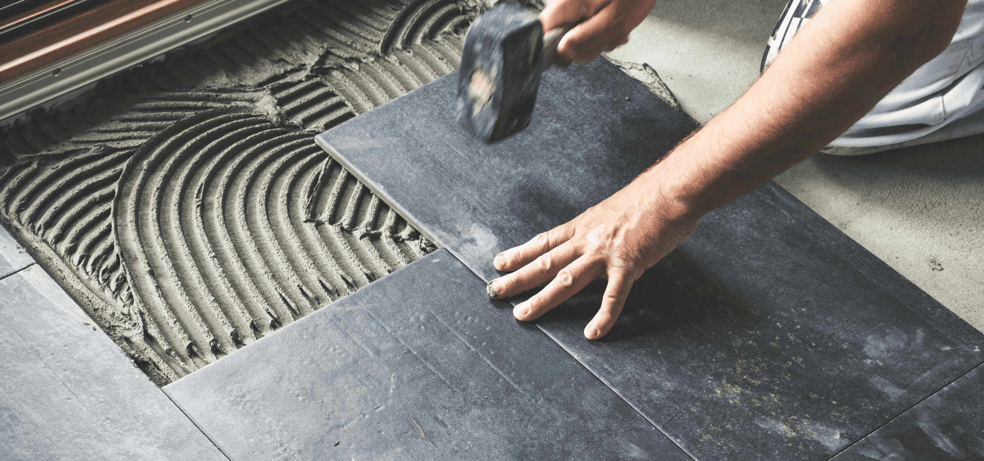 Bathroom remodeler installing eco-friendly ceramic bathroom floor tiles