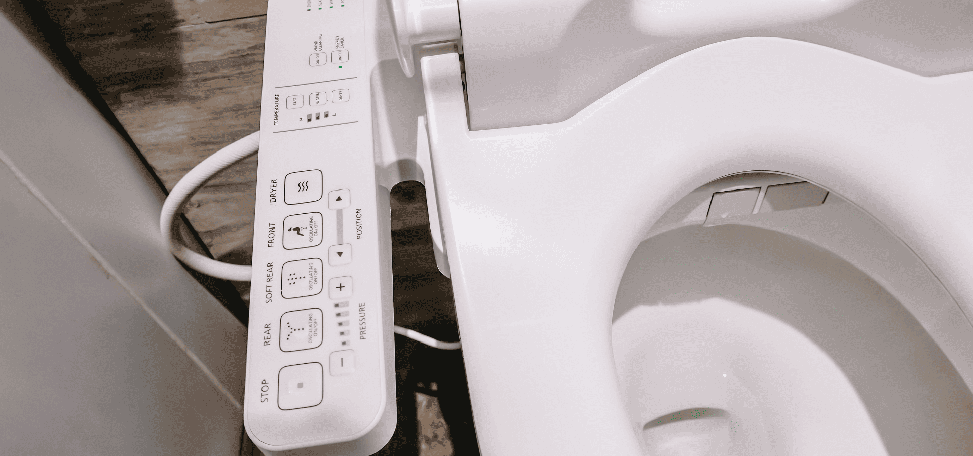 Close-up shot of the controller for a smart toilet in a luxury bathroom