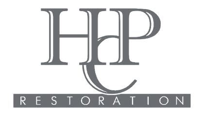 Gray &ldquo;HHP&rdquo; logo with &ldquo;RESTORATION&rdquo; in spaced white letters on a dark banner below.