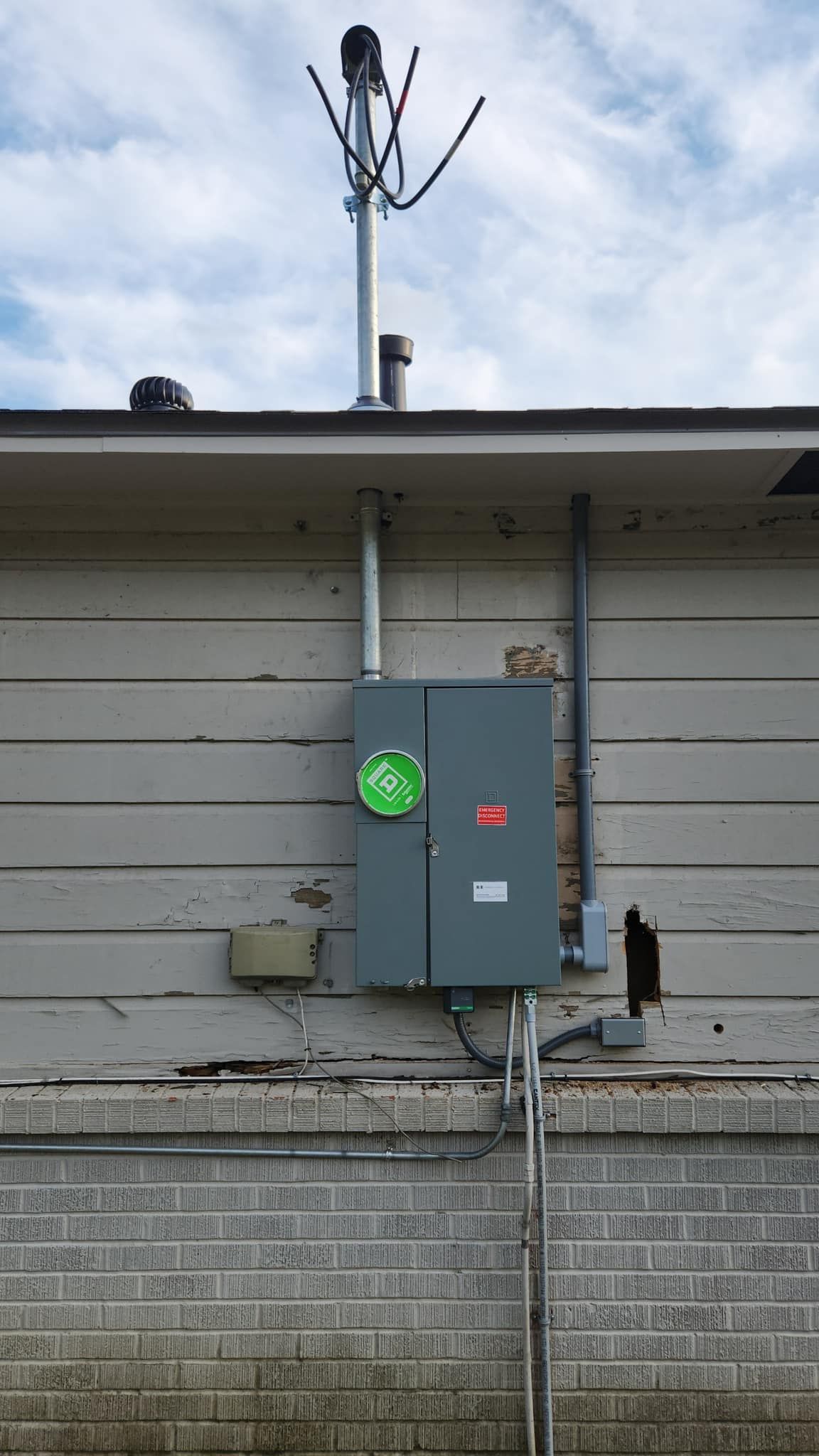 There is a green light on the side of a building.