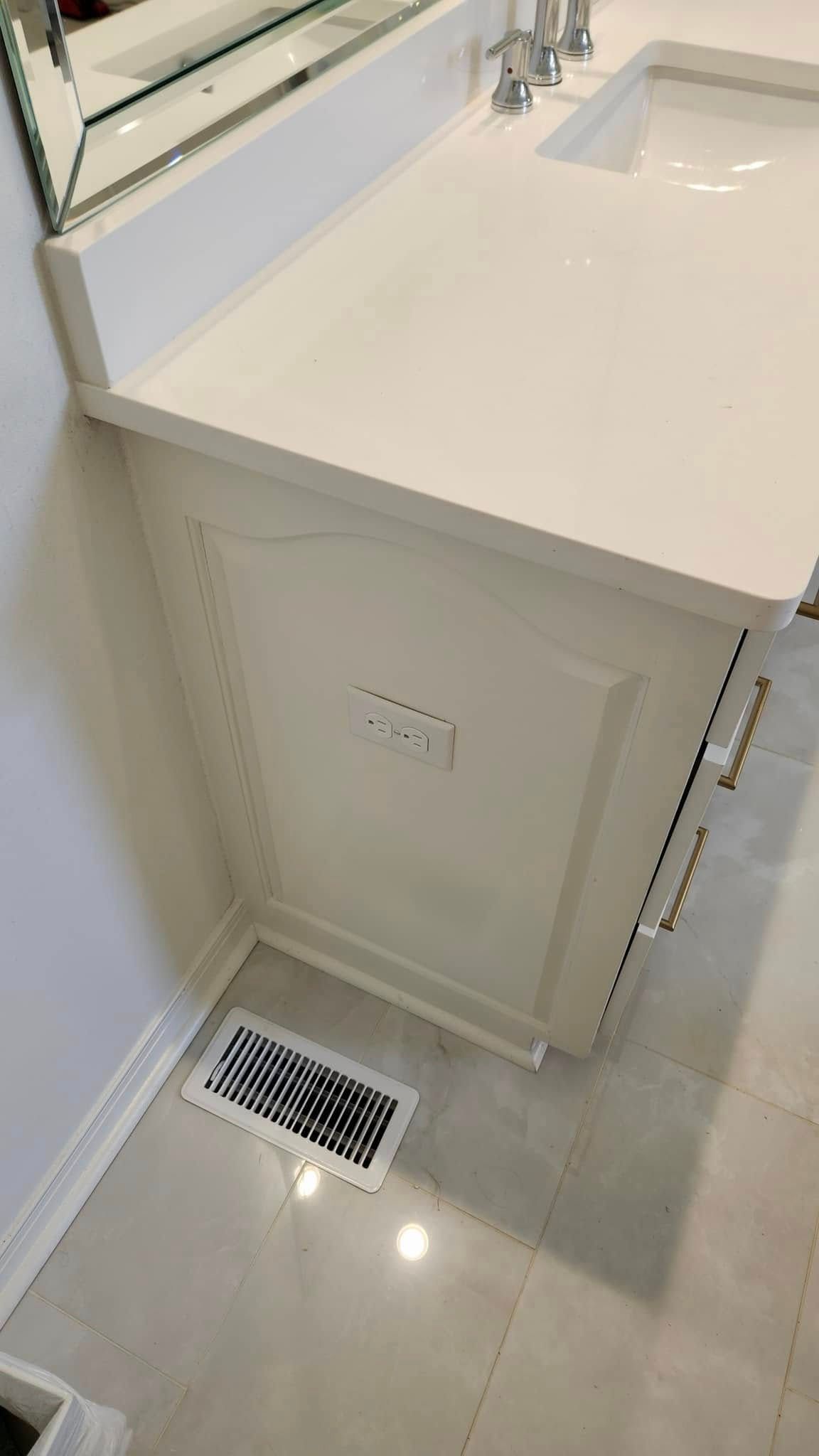 A bathroom sink with a white counter top and a mirror.