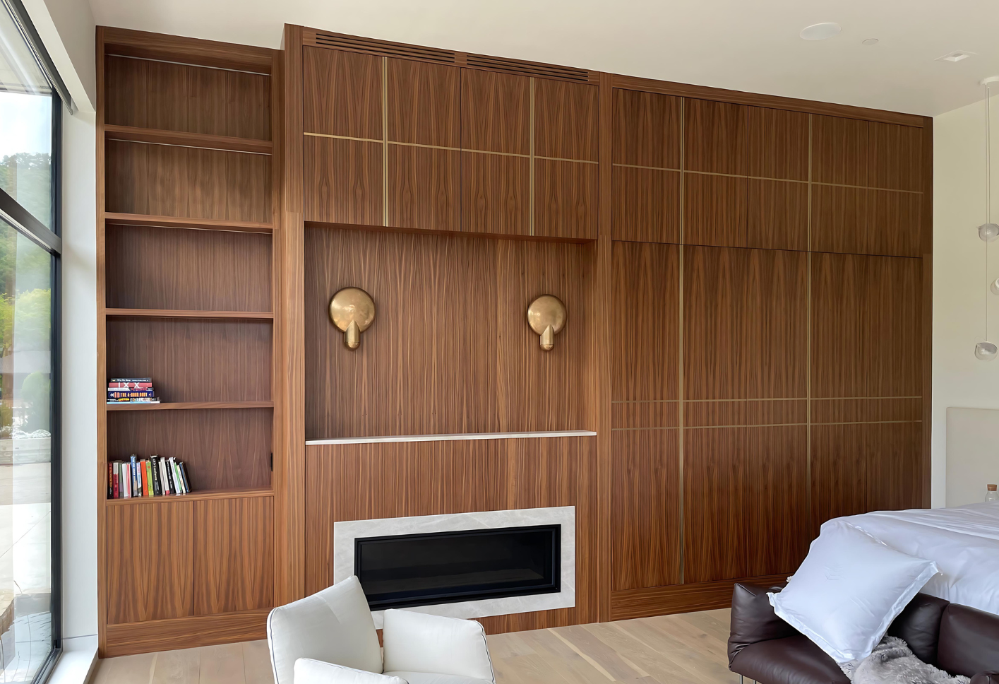 A living room with a fireplace , couch , and shelves.