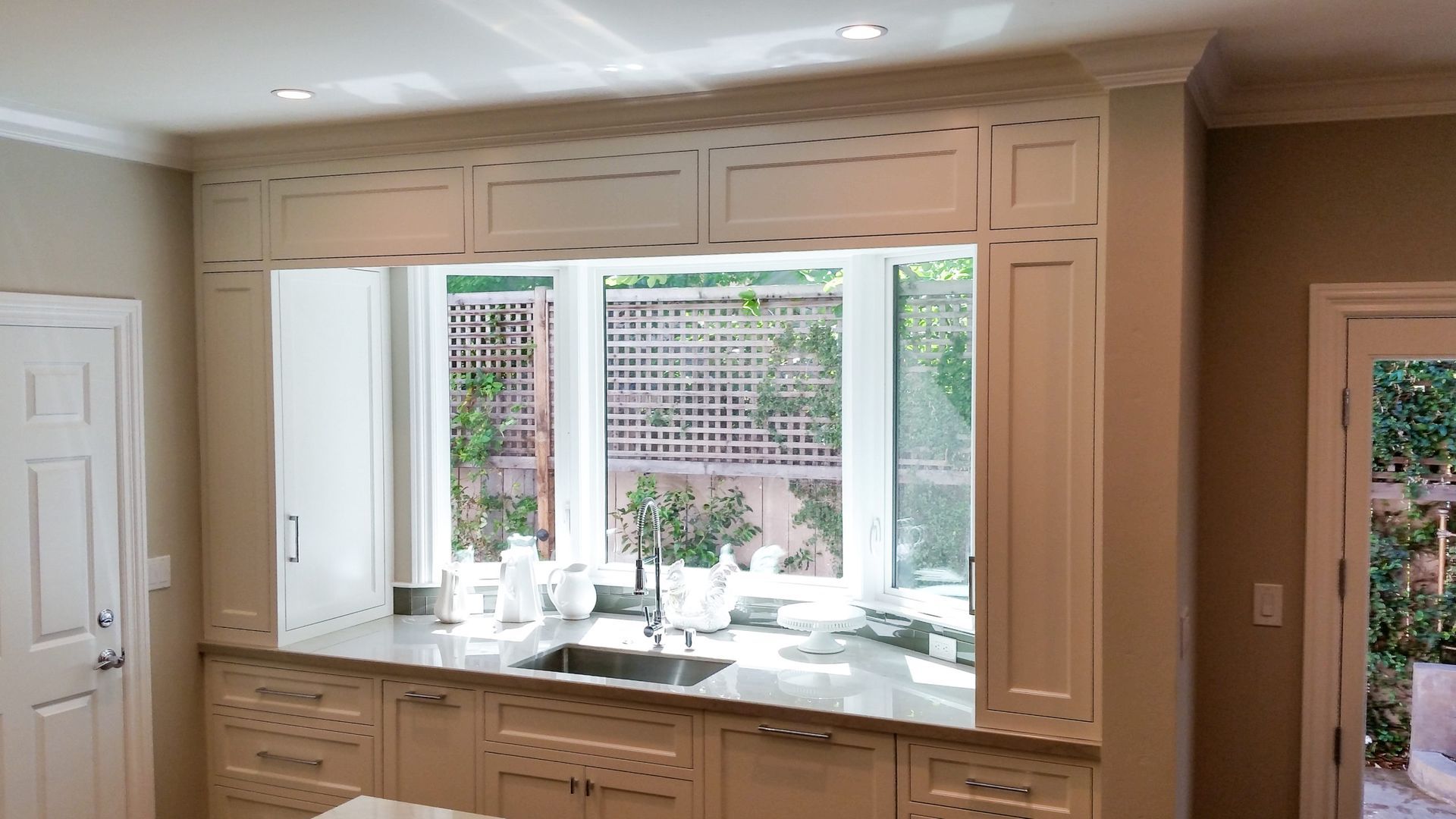 A kitchen with a sink and a large window.