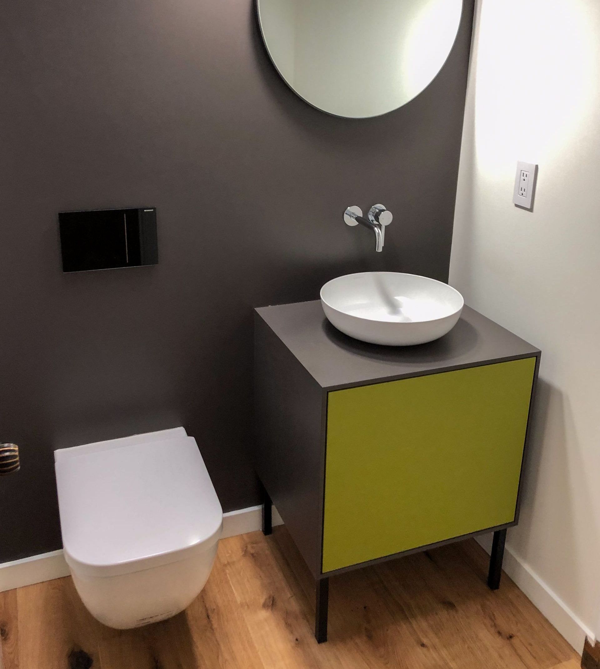 A bathroom with a toilet a sink and a mirror