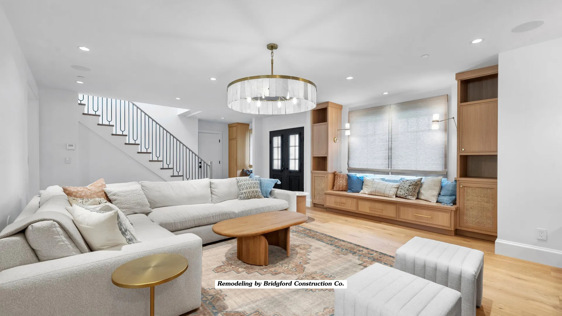 A living room filled with furniture and a staircase.