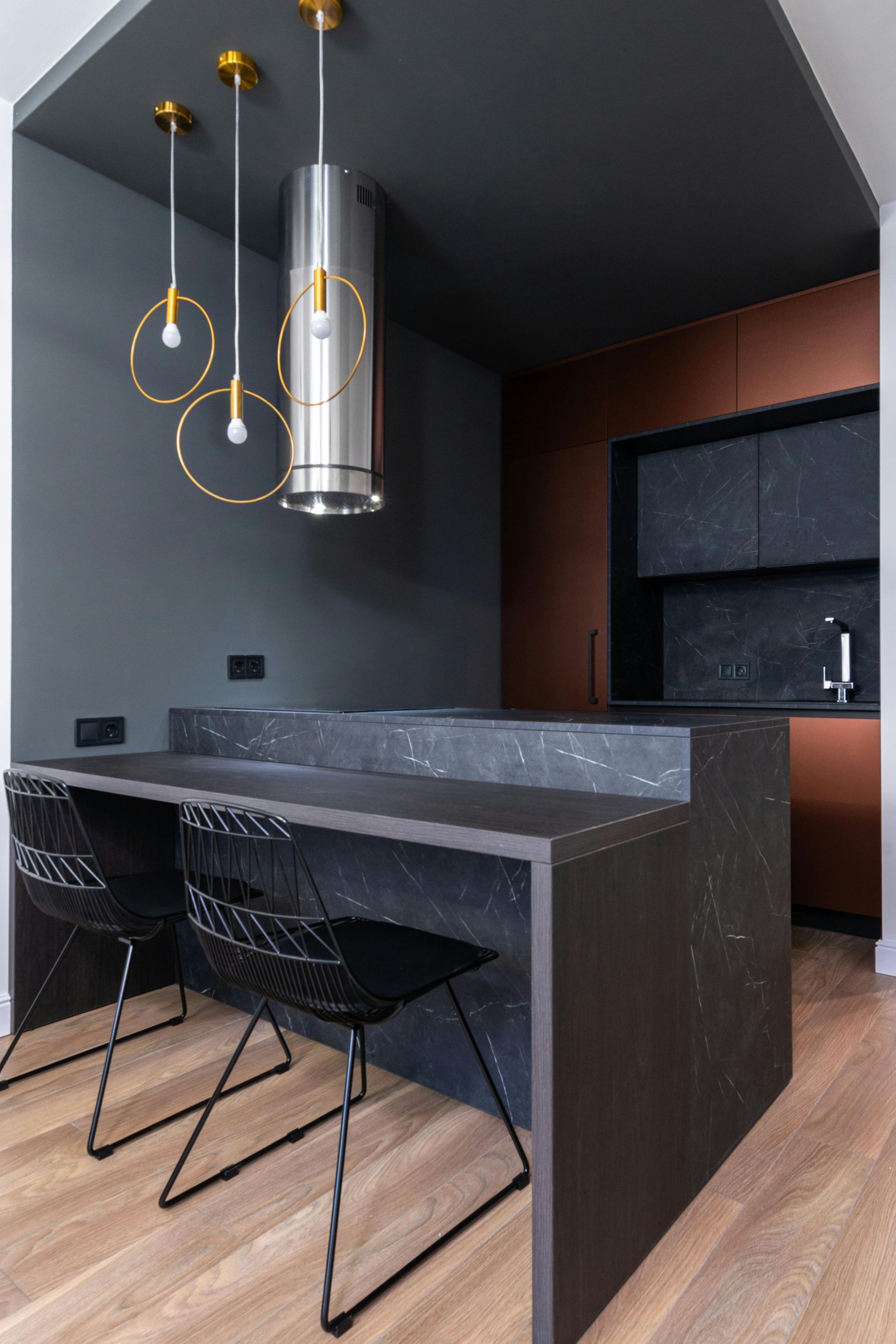 A kitchen with a table and chairs and a ceiling fan.