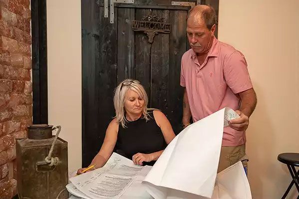A man and a woman are looking at a piece of paper.