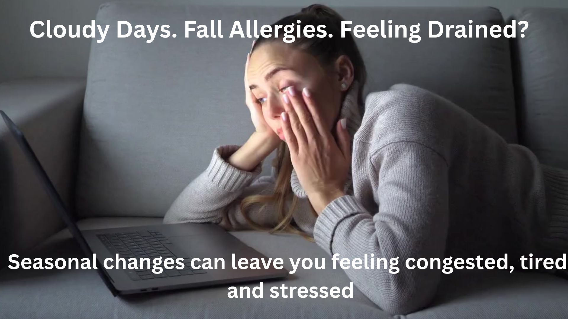 Woman looking tired, resting her head on her hand near a laptop, with text about seasonal fatigue.