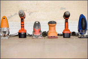  Six handheld power tools including drill and sander