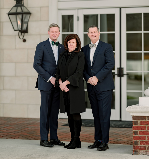 A fountain in a park with palm trees in the background