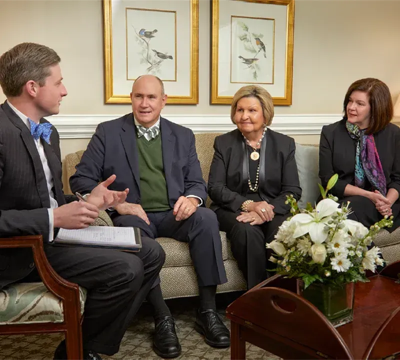 A person is taking a picture of a man and a boy in a photo album.