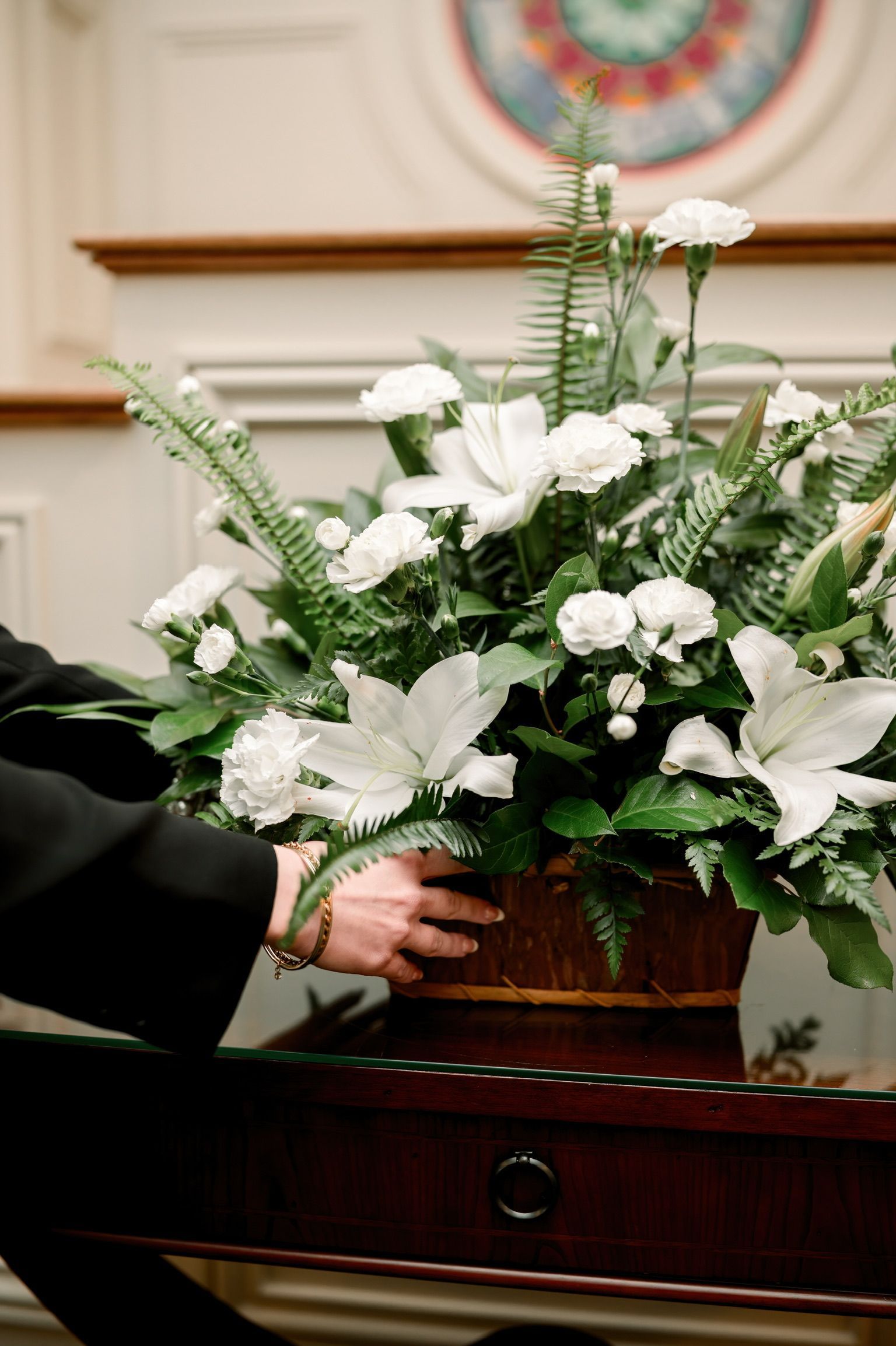 A woman is sitting on a couch talking to a little girl.