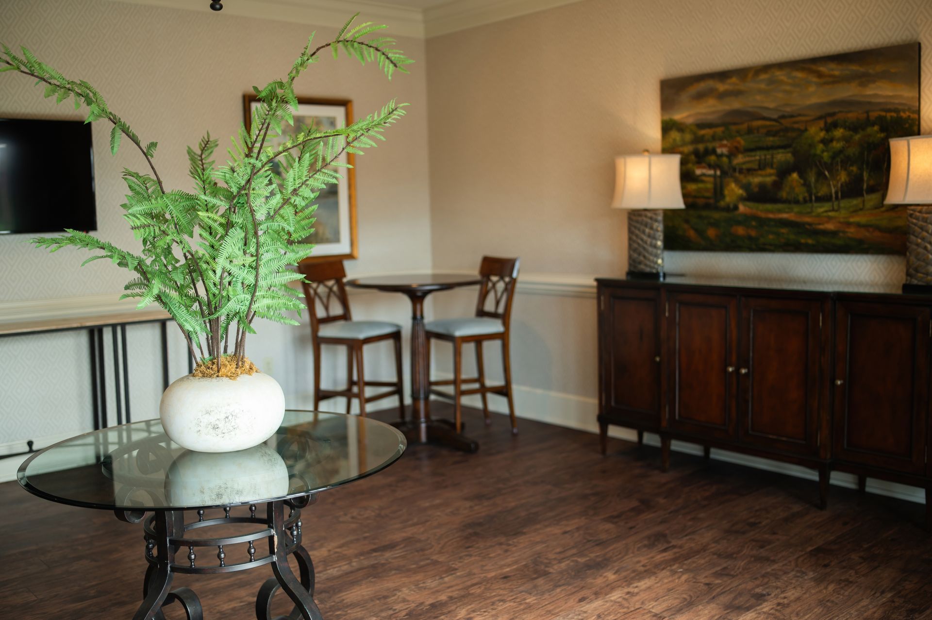 A group of people are sitting in a circle holding hands and talking to each other.