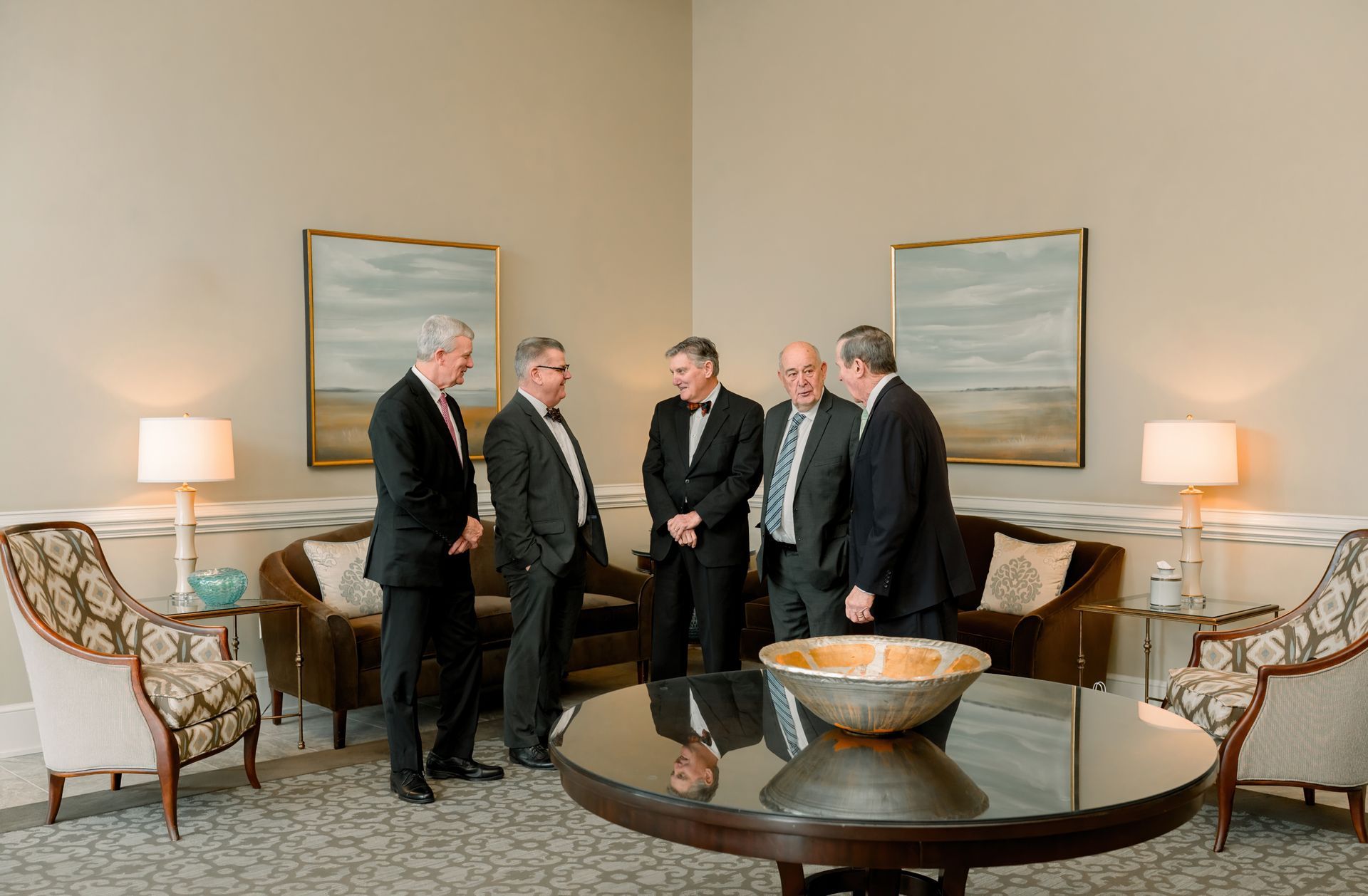 A fountain in a park with palm trees in the background