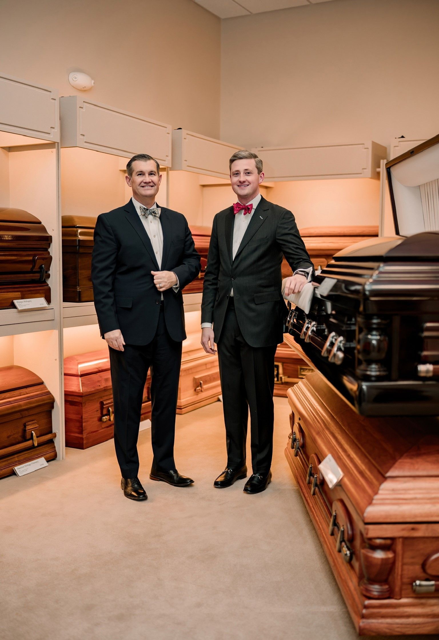 A group of people are standing around a coffin at a funeral.