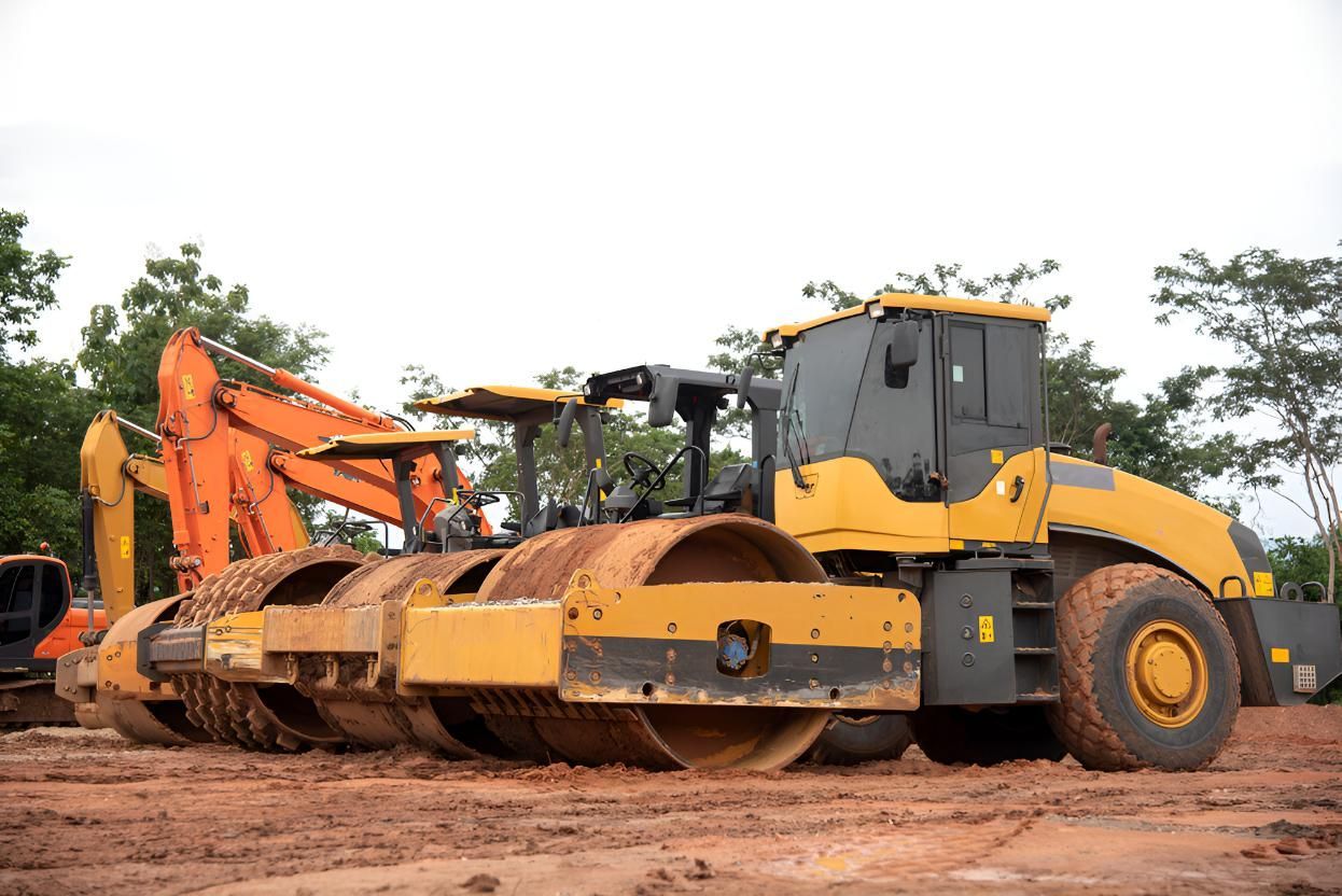 Row of Construction Vehicles Are Parked in a Dirt Lot — L&V Civil Contracting in Park Ridge, QLD