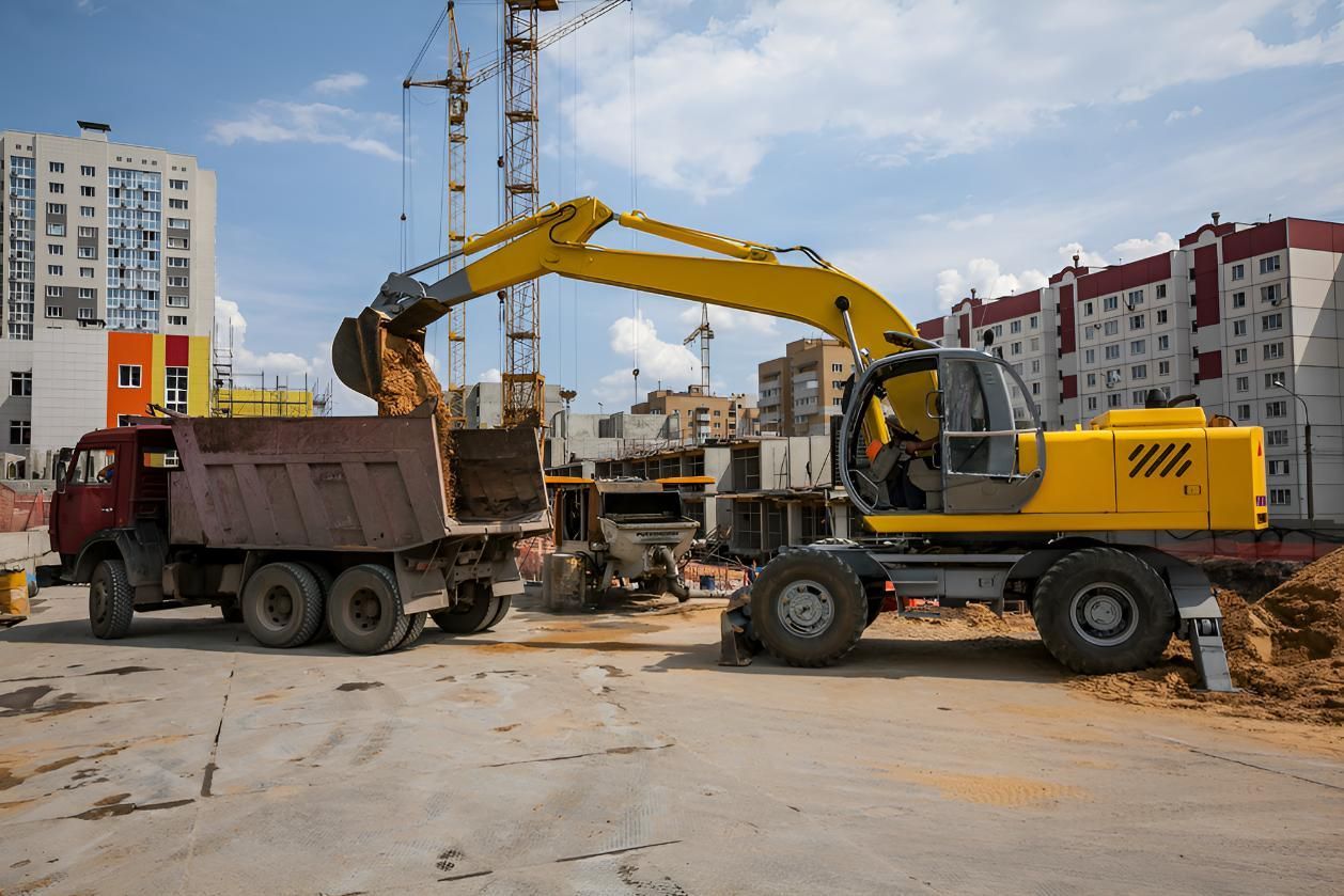 Yellow Excavator is Loading Dirt Into a Dump Truck — L&V Civil Contracting in Park Ridge, QLD