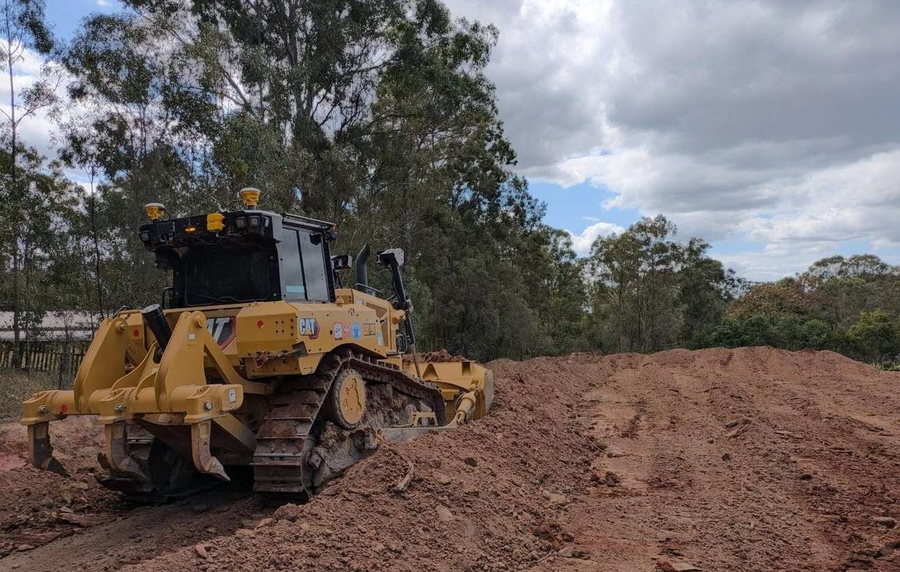 A Bulldozer Is Sitting in The Middle of A Dirt Field  — L&V Civil Contracting in Park Ridge, QLD