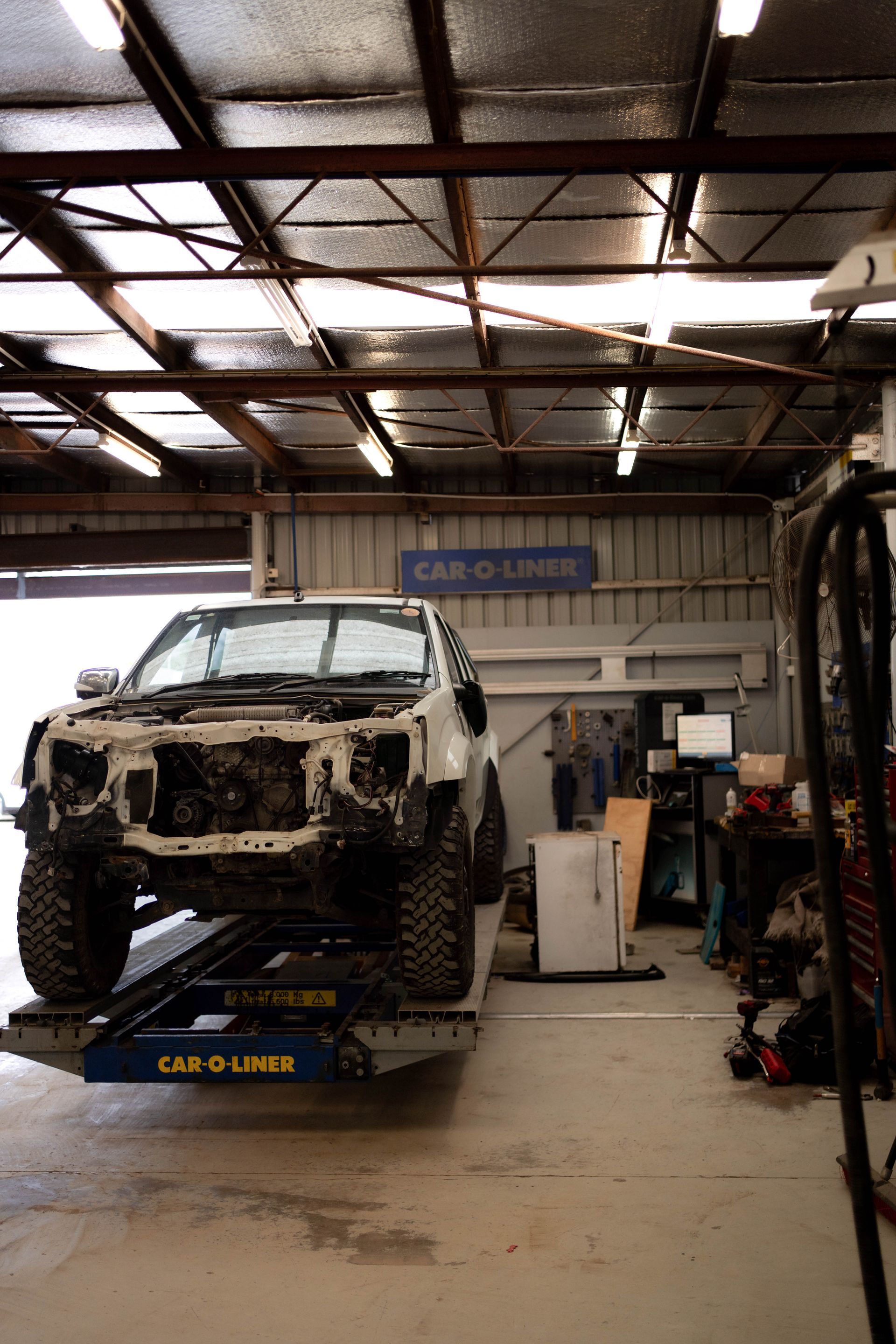 A Car being lifted for chassis service— Douglas Collision Management In Currajong, QLD