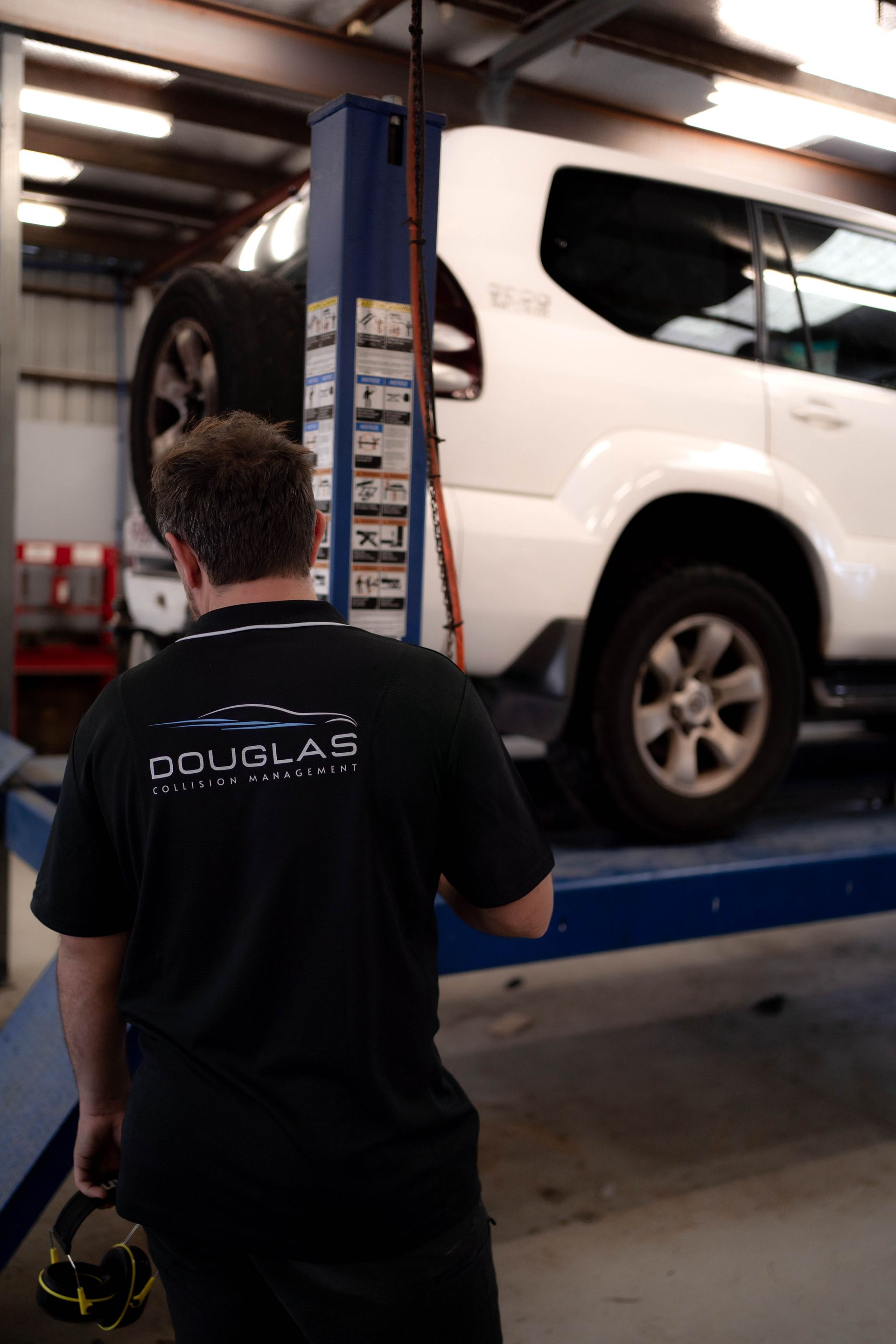 A Man is Working on Car — Douglas Collision Management In Currajong, QLD