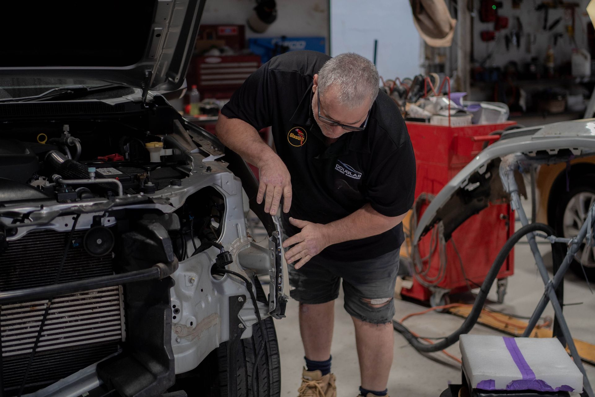 Man doing panel beating work on front of a car — Douglas Collision Management In Currajong, QLD