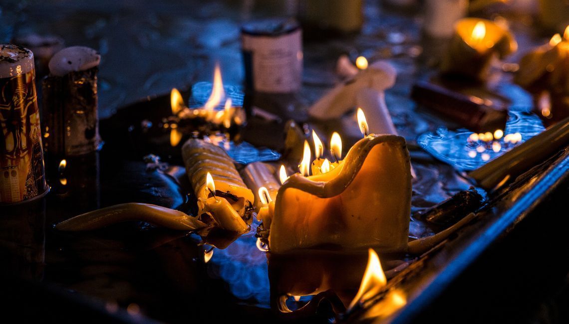 Llamas de velas en vigilia comunitaria que ilustran el sincretismo religioso y el mestizaje en práct
