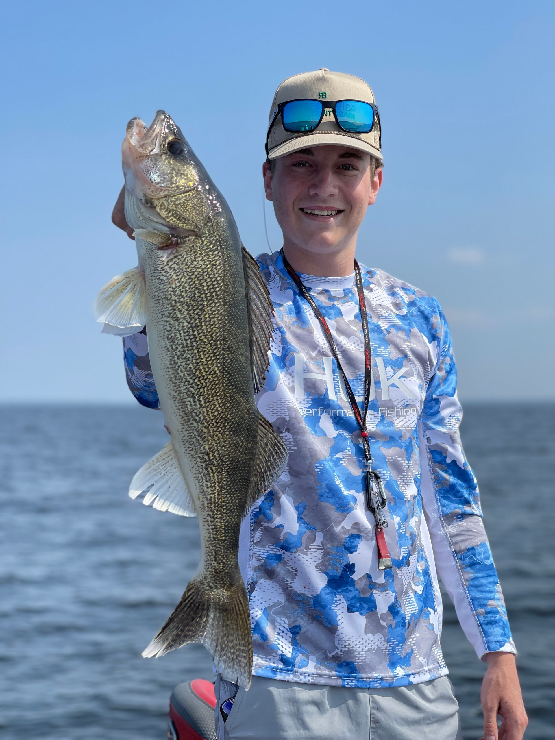 Jordan Peterson holding a walleye he caught while fishing