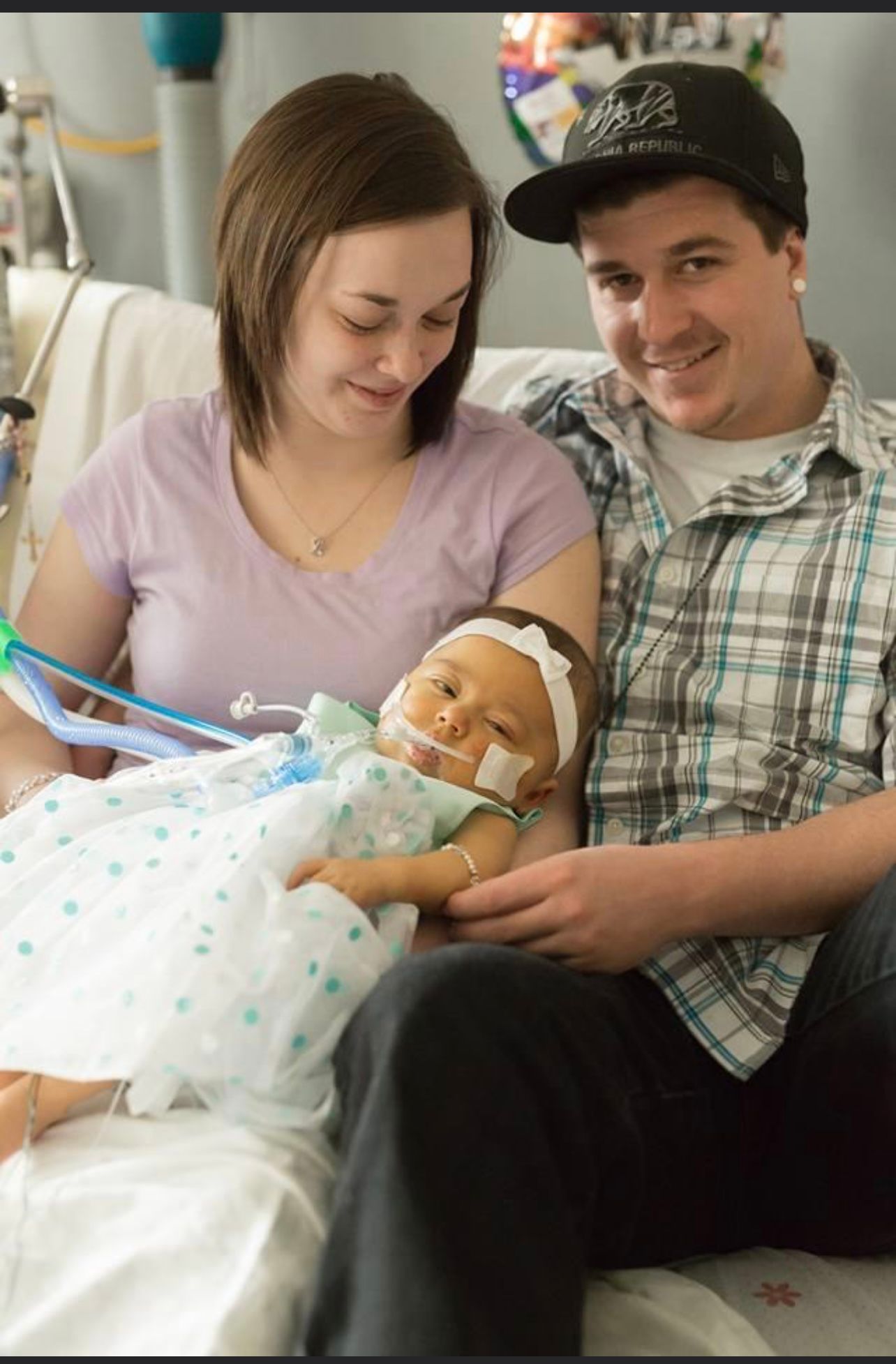 Emily King and her husband holding their newborn baby girl