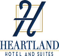A logo for a hotel and suites called heartland hotel and suites.