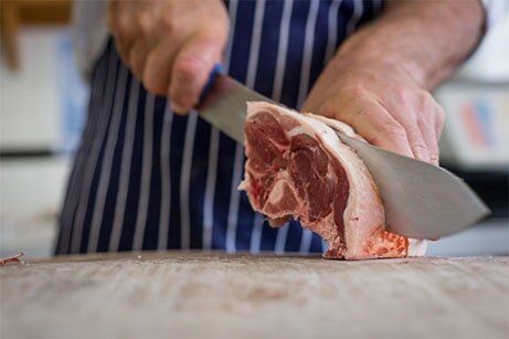 Man cutting meat — Wholesale butcher Dubbo - Bulk Meat