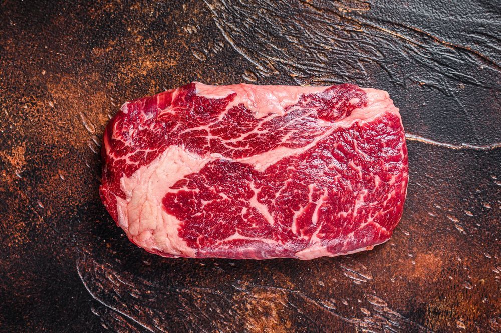Raw rib eye beef meat steak on a butcher table — Wholesale Butchery in Dubbo, NSW