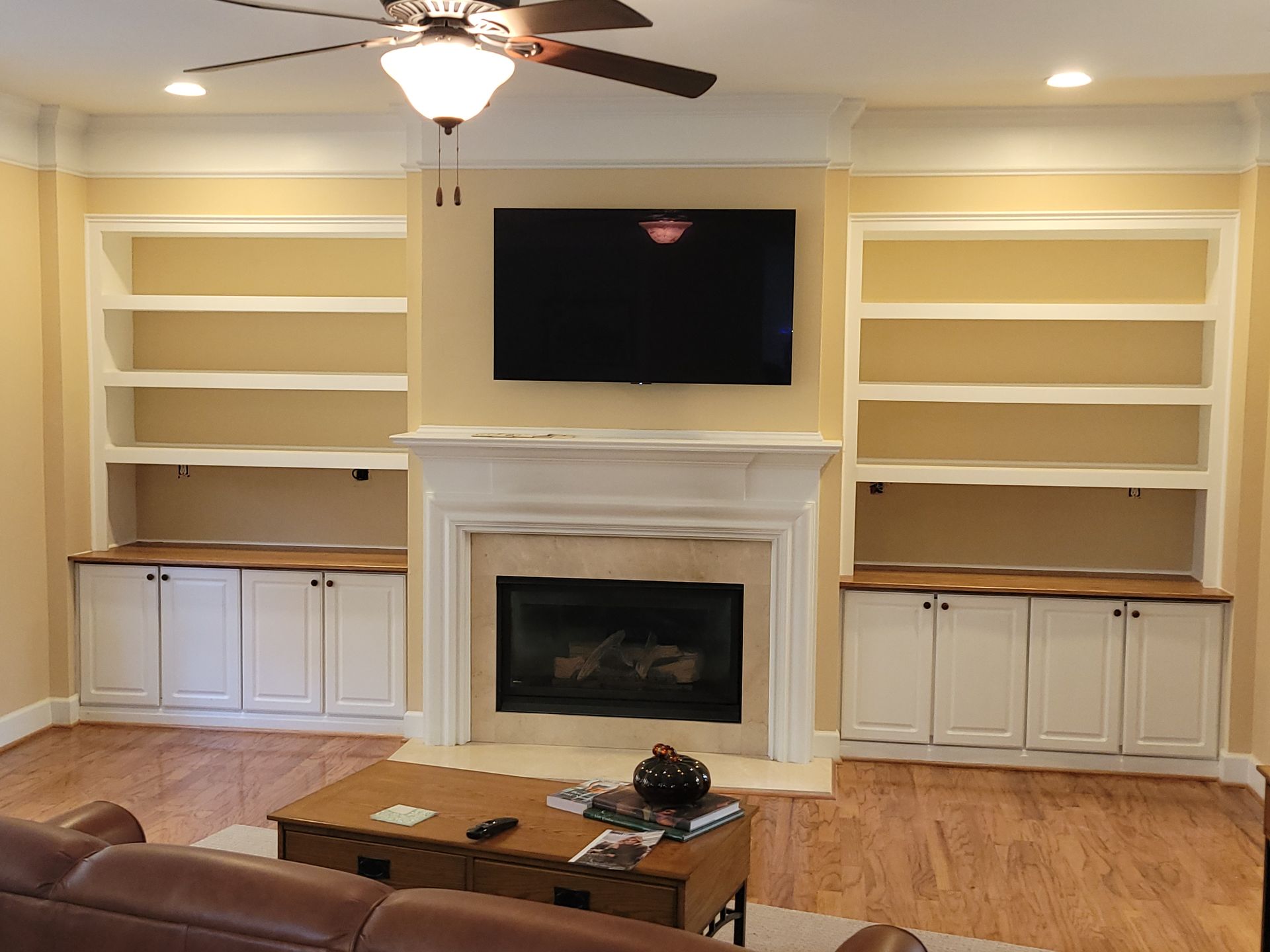 A living room with a fireplace and a flat screen tv