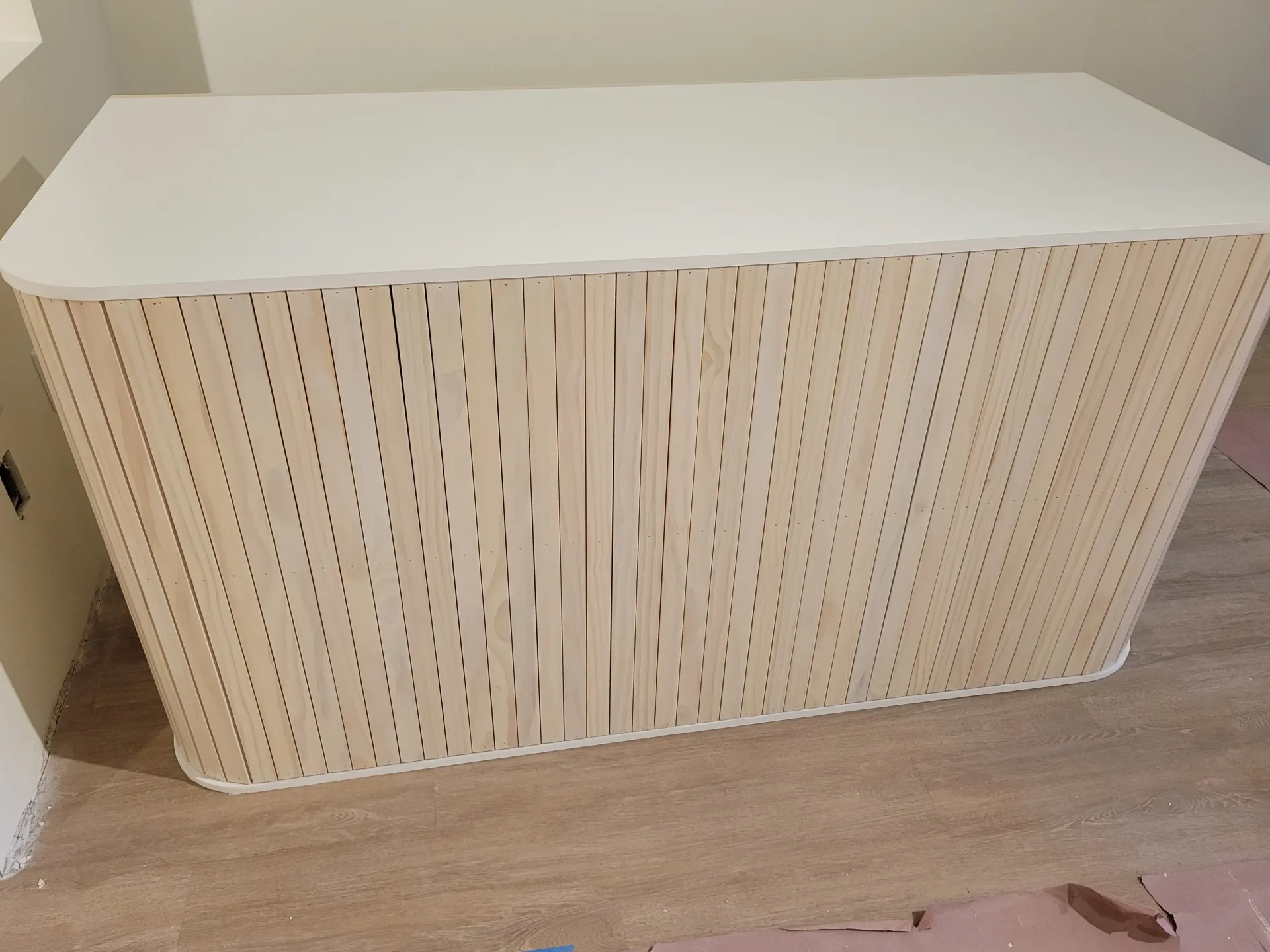 A white box with holes in it is sitting on the floor