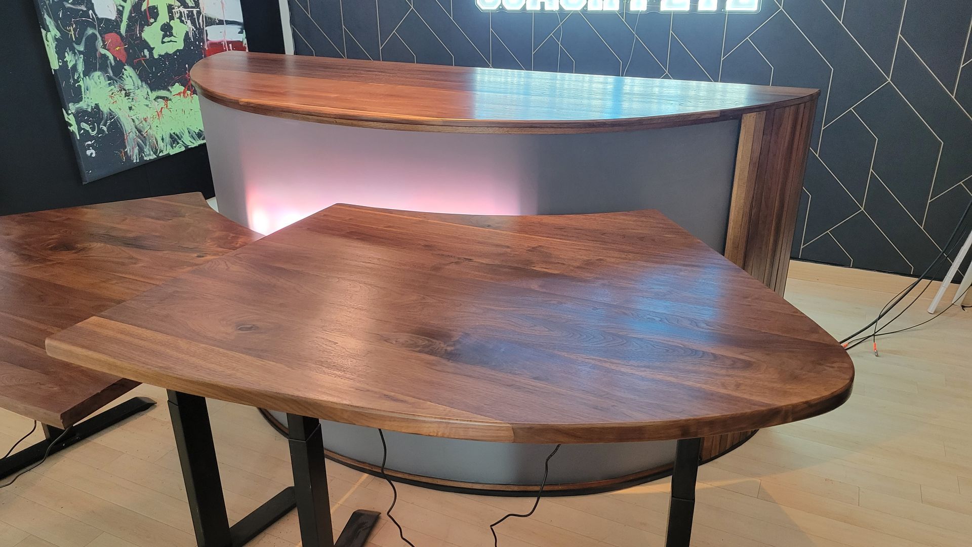 A wooden table with a metal frame is sitting on a wooden floor.