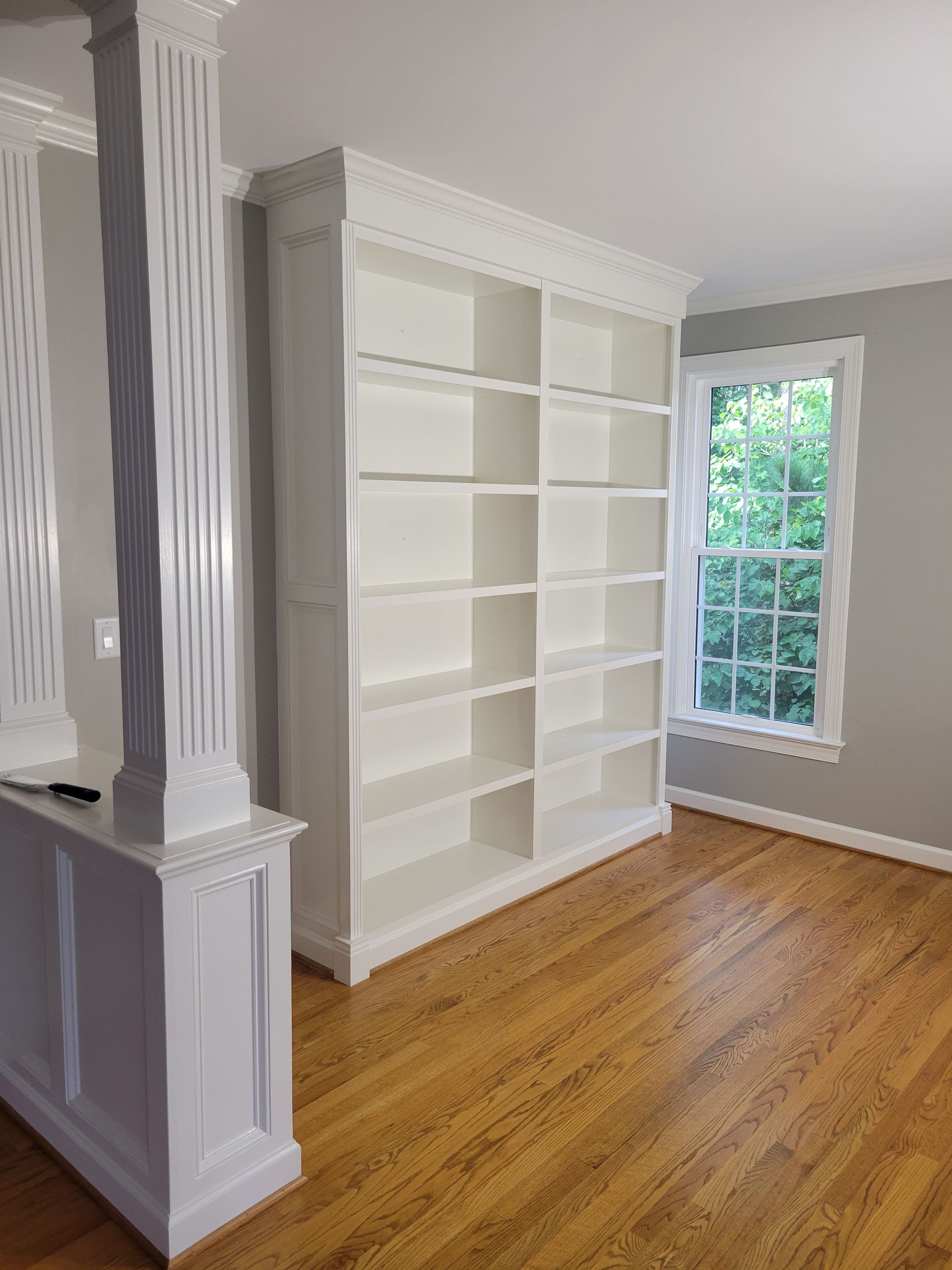 There is a large bookshelf in the middle of the room.